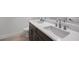 Bathroom showcasing a double sink vanity with dark cabinets and modern fixtures at 12898 Harvest Rain Ave, Winter Garden, FL 34787