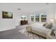 Bright and airy bedroom with neutral tones, large windows, and stylish furnishings at 12898 Harvest Rain Ave, Winter Garden, FL 34787