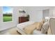 Cozy bedroom features a large window with scenic views, complemented by elegant decor at 12898 Harvest Rain Ave, Winter Garden, FL 34787