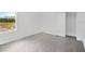 Bedroom with a window, white walls, wood flooring, and a closet at 12898 Harvest Rain Ave, Winter Garden, FL 34787