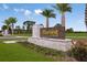 A beautiful entrance to the Harvest at Ovation community is landscaped with palm trees and decorative stone at 12898 Harvest Rain Ave, Winter Garden, FL 34787