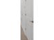 White doors and doorframes line a hallway with wood laminate flooring at 12898 Harvest Rain Ave, Winter Garden, FL 34787