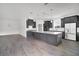 Modern kitchen with gray cabinetry, a spacious island, and stainless steel appliances, perfect for cooking at 12898 Harvest Rain Ave, Winter Garden, FL 34787