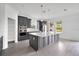 Modern kitchen with stainless steel appliances, gray cabinets, and white countertops at 12898 Harvest Rain Ave, Winter Garden, FL 34787