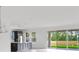 Modern kitchen features gray cabinets, stainless steel appliances, and opens to the patio at 12898 Harvest Rain Ave, Winter Garden, FL 34787