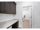 Well-organized laundry room with gray cabinets, counter space, and modern appliances for efficient home chores at 12898 Harvest Rain Ave, Winter Garden, FL 34787
