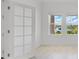 Living room with natural lighting, two windows and a view of the lawn outside at 12898 Harvest Rain Ave, Winter Garden, FL 34787