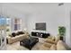 Inviting living room with comfortable seating, natural light, and a contemporary design at 12898 Harvest Rain Ave, Winter Garden, FL 34787