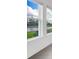 Serene window view showcasing a picturesque pond with clear skies, complementing the interiors at 12898 Harvest Rain Ave, Winter Garden, FL 34787