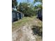 Spacious backyard area, great for outdoor activities, featuring a mix of grass and dirt between two properties at 2915 Winter Lake Rd, Lakeland, FL 33803