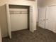 Bright, carpeted bedroom featuring an open closet and multiple doors, offering ample space and functionality at 2915 Winter Lake Rd, Lakeland, FL 33803