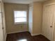 Neutral-toned bedroom with a window, closet, and modern laminate flooring at 2915 Winter Lake Rd, Lakeland, FL 33803