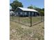 Inviting home featuring a metal roof and a chain-link fence enclosing the yard at 2915 Winter Lake Rd, Lakeland, FL 33803