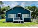 Charming blue and white cottage-style home with a small front porch and well-maintained lawn under a partly cloudy sky at 2915 Winter Lake Rd, Lakeland, FL 33803