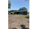 View of the home featuring an enclosed porch and generous yard space at 2915 Winter Lake Rd, Lakeland, FL 33803