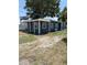 Cozy home with blue siding, visible air conditioning unit, and a mature tree in the yard at 2915 Winter Lake Rd, Lakeland, FL 33803