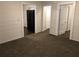 Interior view showing a doorway, the refrigerator, and carpeted flooring at 2915 Winter Lake Rd, Lakeland, FL 33803