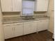 Functional kitchen with clean, white cabinetry, ample countertop space, and durable laminate flooring at 2915 Winter Lake Rd, Lakeland, FL 33803
