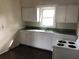 A simple kitchen featuring a white sink and cabinetry, with an electric range stove at 2915 Winter Lake Rd, Lakeland, FL 33803