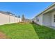 Backyard featuring exterior view of home, lush grass, mulch, privacy fence, and shrubbery at 5920 Bristle Oak St, Mount Dora, FL 32757