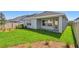 Backyard featuring exterior view of home, lush grass, mulch, and privacy fence at 5920 Bristle Oak St, Mount Dora, FL 32757