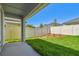 Backyard featuring privacy fence, grass, and mulch with a view from the covered patio at 5920 Bristle Oak St, Mount Dora, FL 32757