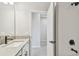 Bright bathroom showcasing a tiled shower, white vanity, and matte black fixtures at 5920 Bristle Oak St, Mount Dora, FL 32757