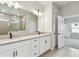 Bright bathroom featuring double vanity, matte black fixtures, tiled floor, and glass-enclosed shower at 5920 Bristle Oak St, Mount Dora, FL 32757