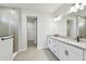 A bathroom with double sinks, a walk-in shower and a door leading to the walk-in closet at 5920 Bristle Oak St, Mount Dora, FL 32757