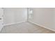 Neutral bedroom featuring plush carpeting, a single window, and white baseboards at 5920 Bristle Oak St, Mount Dora, FL 32757