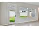 A modern living area with a glass back door and a set of large windows overlooking the backyard at 5920 Bristle Oak St, Mount Dora, FL 32757