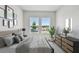 A stylish and serene main bedroom features large windows that provide plenty of natural light at 5920 Bristle Oak St, Mount Dora, FL 32757