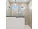 Modern tiled shower featuring two shower heads, clear glass surround, and multiple transom windows at 5920 Bristle Oak St, Mount Dora, FL 32757