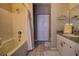 Clean bathroom featuring a shower and bath combo, a spacious vanity, and coordinated fixtures and lighting at 6300 Raleigh St # 102, Orlando, FL 32835