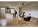 Well-lit dining and kitchen area with stainless appliances, breakfast bar and modern dining table with gold accents at 6300 Raleigh St # 102, Orlando, FL 32835