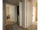 Hallway with multiple closet doors, a laundry room and hardwood flooring creating a sense of openness and functionality at 6300 Raleigh St # 102, Orlando, FL 32835