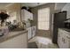 Efficient kitchen featuring white cabinetry, neutral countertop, and essential appliances, ideal for home cooking at 6300 Raleigh St # 102, Orlando, FL 32835