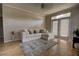 Cozy living room with hardwood floors, a comfortable sofa, and large windows filling the space with natural light at 6300 Raleigh St # 102, Orlando, FL 32835