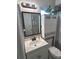 Bathroom with a modern vanity, mirror, and cabinet above the toilet for storage and a shower at 730 Barber Cir, Lakeland, FL 33803