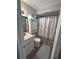 Cozy bathroom featuring a vanity, mirror, and a shower with a stylish curtain and soft accent rug at 730 Barber Cir, Lakeland, FL 33803