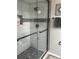 Beautiful tiled walk-in shower with glass doors and bronze hardware in the bathroom at 730 Barber Cir, Lakeland, FL 33803