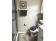 Bathroom featuring a walk-in shower, toilet, and vanity, complete with decorative accents and gray towels at 730 Barber Cir, Lakeland, FL 33803