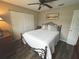 Warm bedroom with a bed with decorative pillows, ceiling fan, and large wardrobe closet at 730 Barber Cir, Lakeland, FL 33803