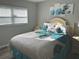 Bright bedroom with a comfortable bed, calming artwork, and a large window with blinds at 730 Barber Cir, Lakeland, FL 33803