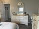 Bedroom view with dresser and mirror and view into the en suite bathroom with lots of storage at 730 Barber Cir, Lakeland, FL 33803