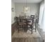 Cozy dining area featuring a wooden table, four chairs, and a stylish overhead light fixture at 730 Barber Cir, Lakeland, FL 33803