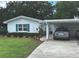 Single story home with a well-maintained yard and covered parking at 730 Barber Cir, Lakeland, FL 33803