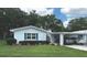 Charming single story home featuring a well-manicured lawn and covered parking at 730 Barber Cir, Lakeland, FL 33803