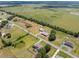 Overhead view featuring a home, outbuildings, and expansive fields, highlighting the rural charm and spaciousness of the property at 14365 Evans Ranch Rd, Lakeland, FL 33809