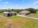 Aerial view of a property showing a home with a large yard, two garages, and a long driveway at 14365 Evans Ranch Rd, Lakeland, FL 33809